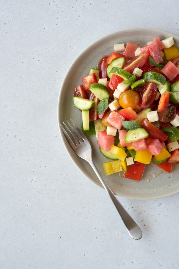 Top down of a plate full of colorful fruit and veggies