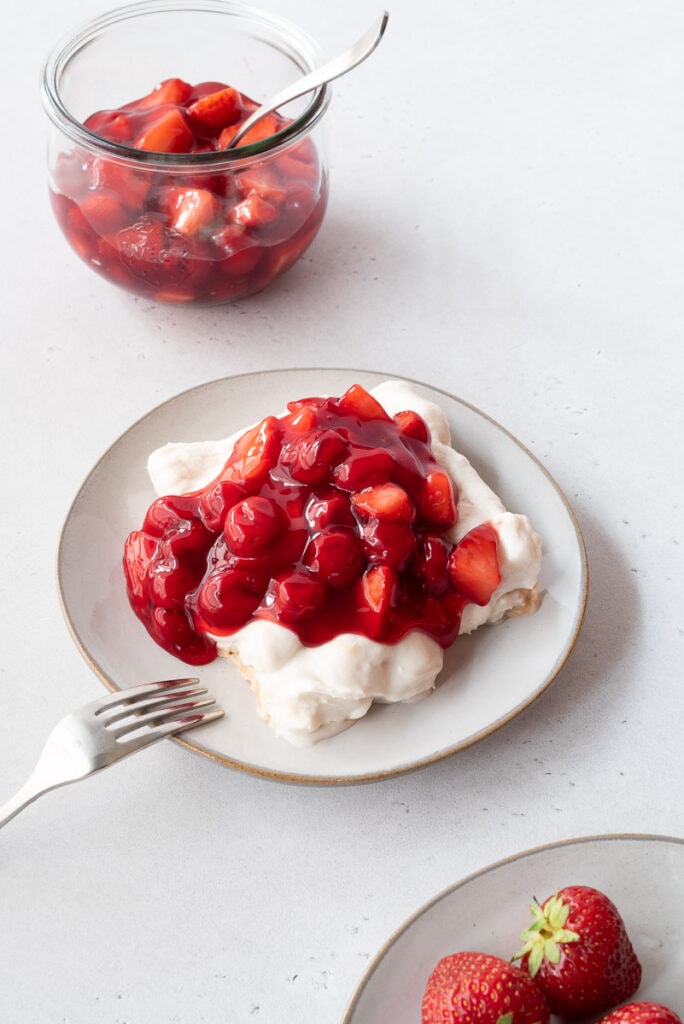 Plate with meringue dessert and cherries