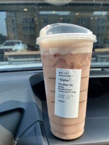 Iced Starbucks drink sitting on a car dashboard