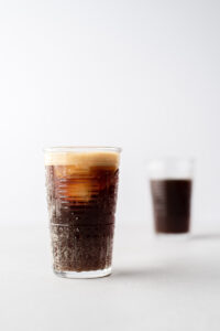 Two glasses of fizzy brown cacao soda