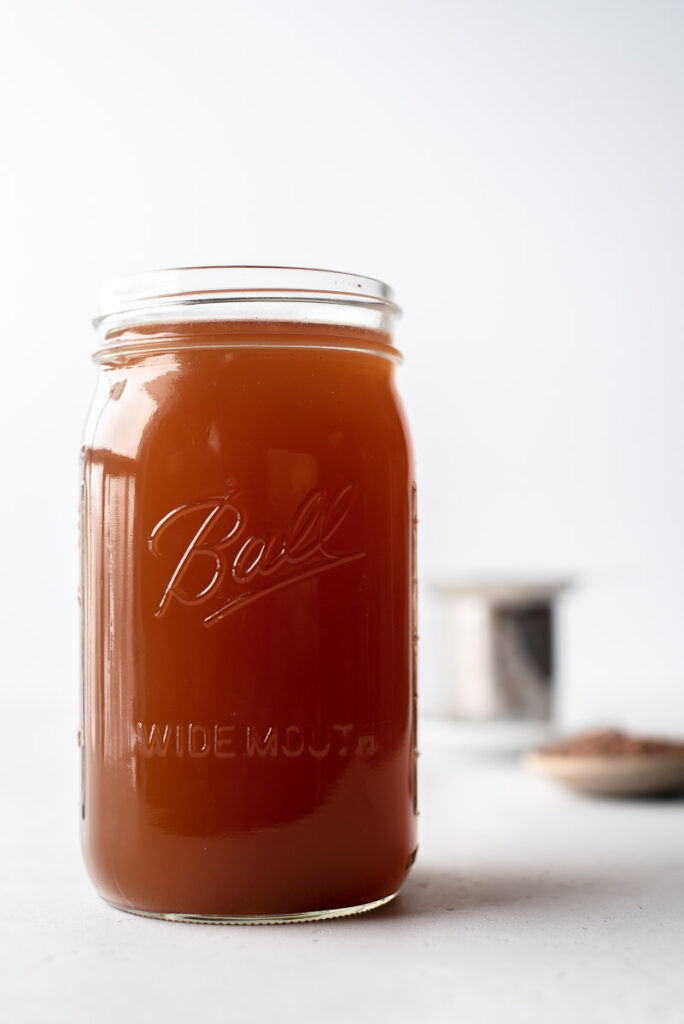 Large mason jar full of brewed brown cacao tea