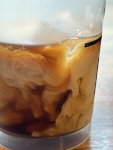 Close up of iced coffee swirled with milk