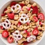 Close up on white bowl full of Valentine snack mix