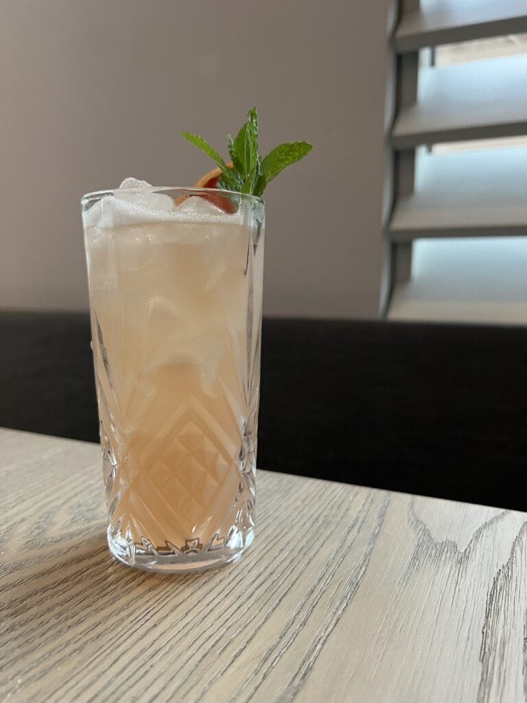 Pink cocktail in a glass on a restaurant table