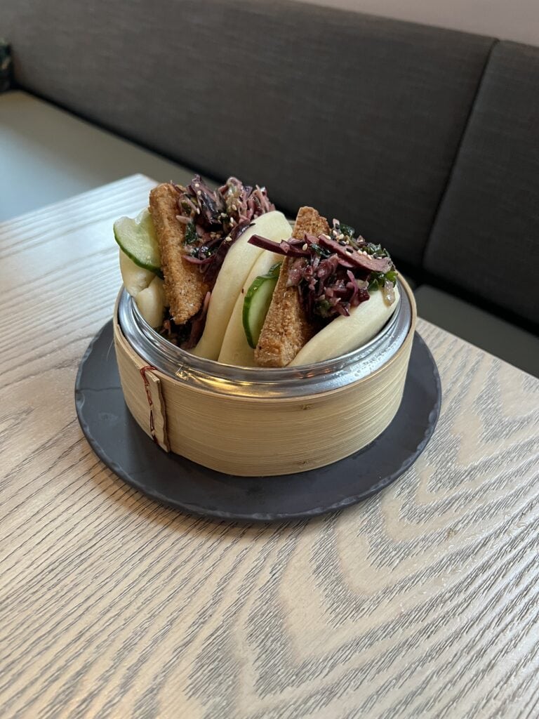 Bamboo steamer filled with two bao tacos