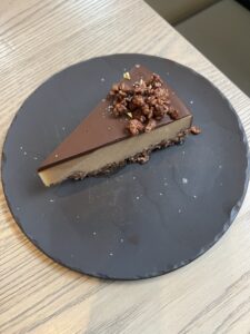 Piece of chocolate peanut butter pie on a black plate