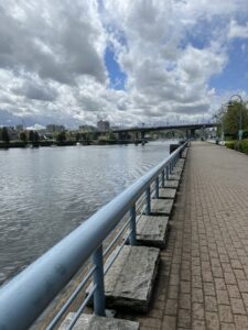 Cloud filled sky over a walkway near the water