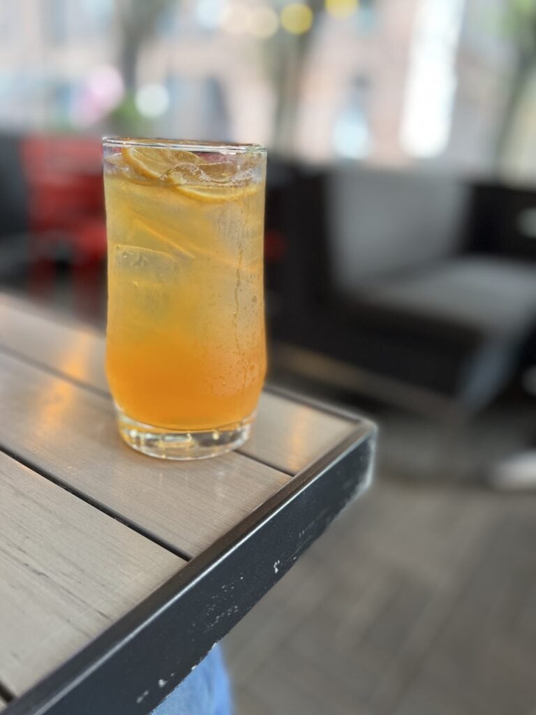 Glass of iced tea on the corner of a restaurant table