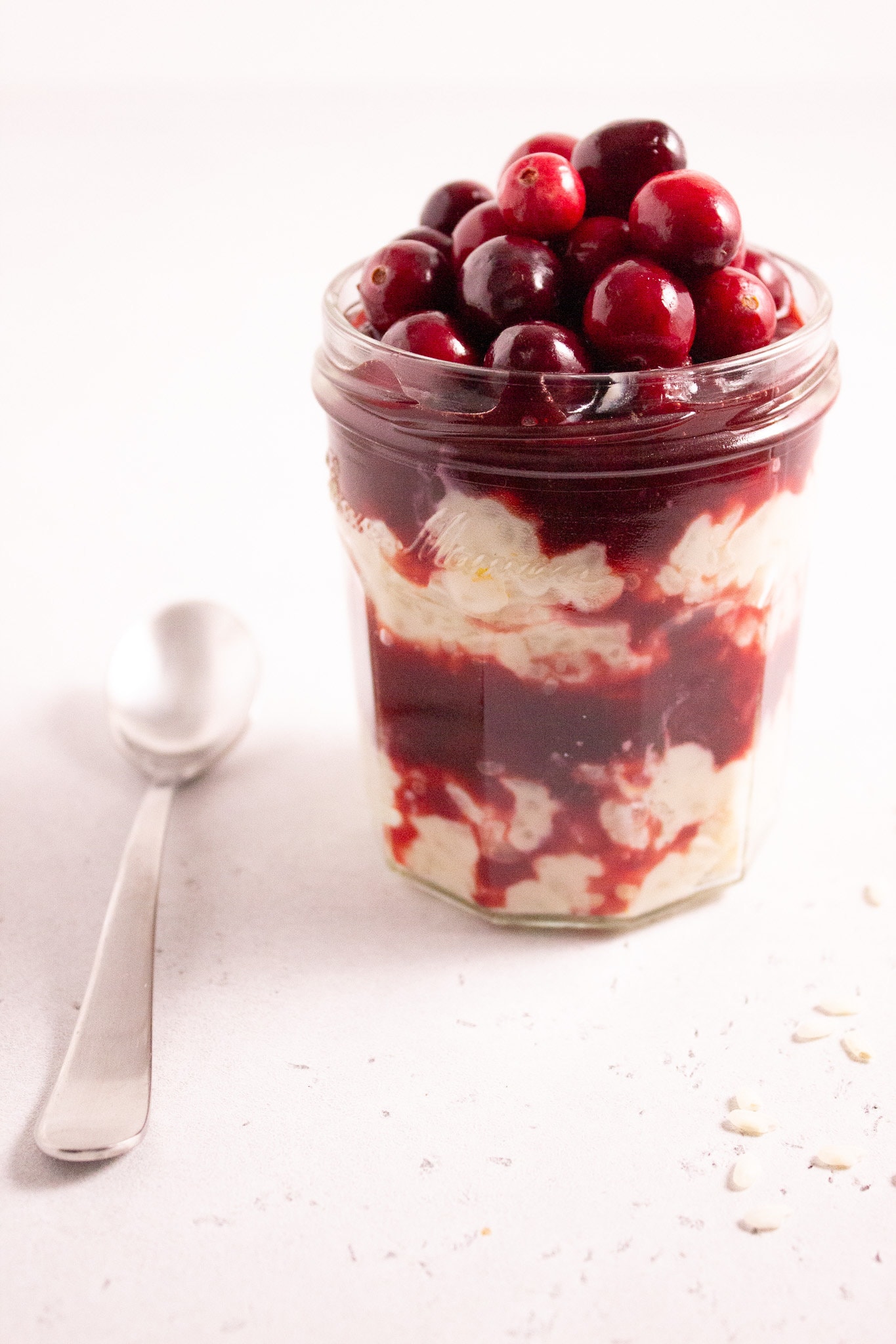 Jar layered with rice pudding and cranberry sauce