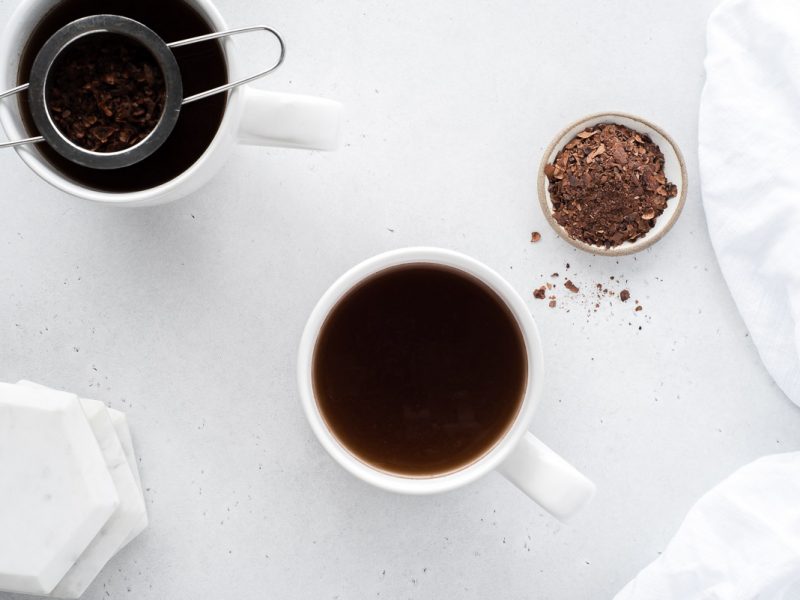 Top down view of two cups of cacao tea