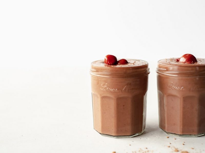 two glasses of chocolate cherry smoothie side by side