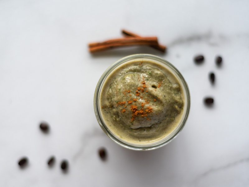 top down view of a cinnamon coffee smoothie in a jar