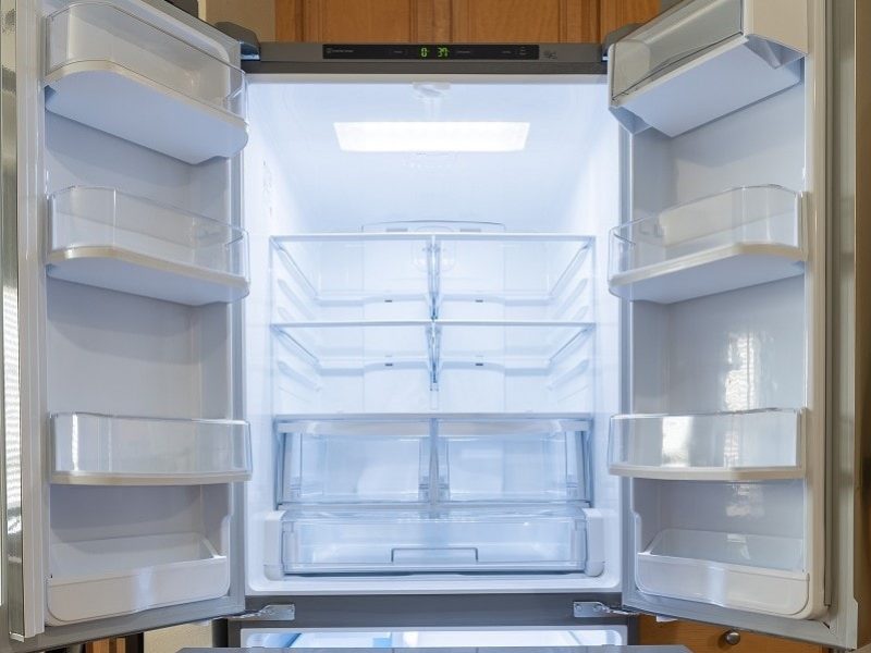 Empty French door refrigerator with doors open