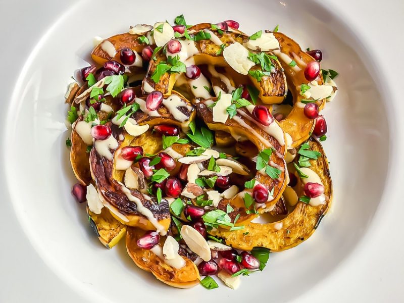 Plate of delicata squash with pomegranate