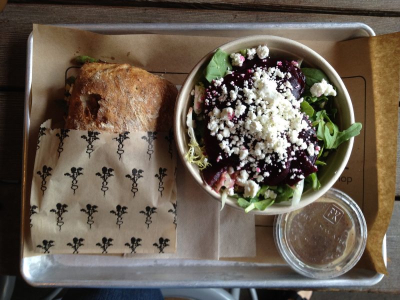 Sandwich and salad on a metal lunch tray