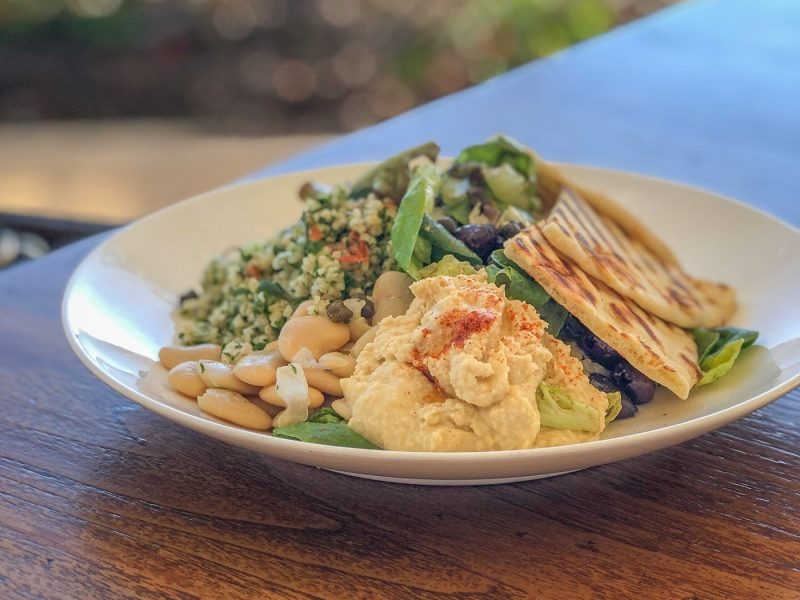 Plate filled with beans, pita and hummus