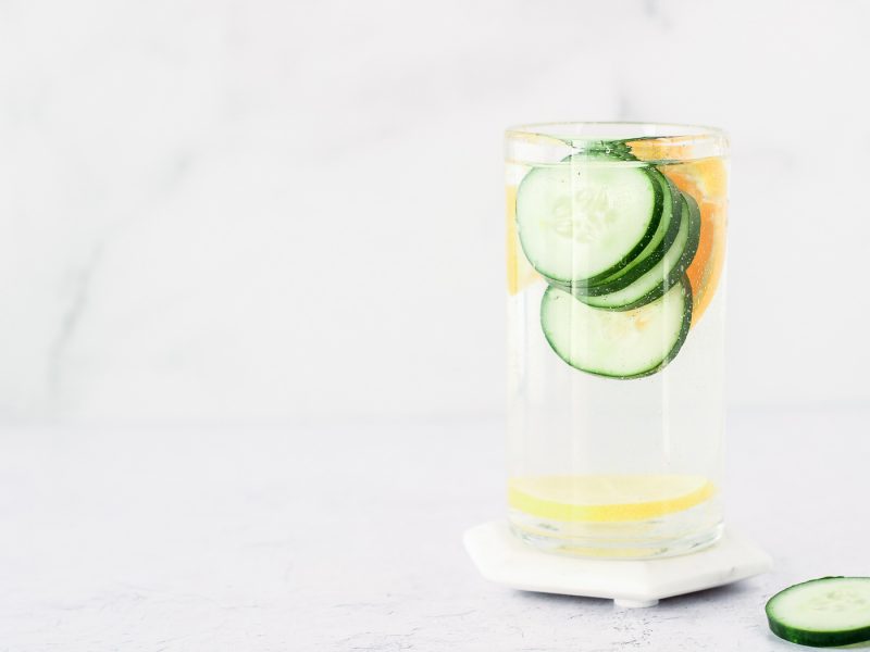 Glass of water with cucumbers slices
