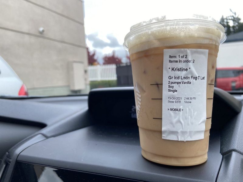 Iced Starbucks drink sitting on the dashboard of a car