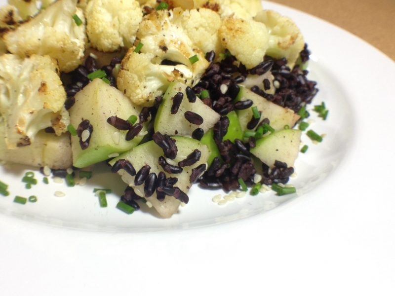 Cauliflower, black rice and apple on a plate