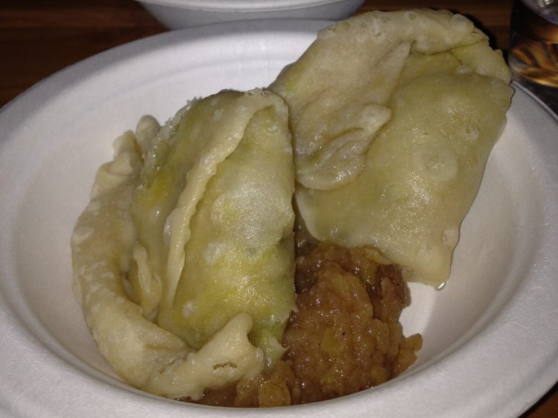 2 samosas in a paper bowl