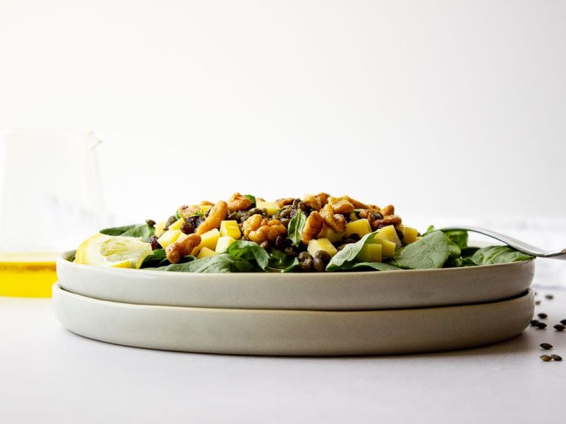 Side view of two stacked plates filled with salad