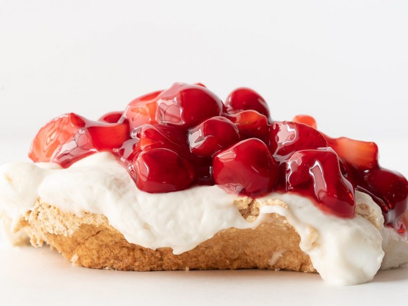 Meringue dessert topped with cherries